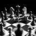A captivating black and white photo of a chess game with fallen king piece, symbolizing defeat.
