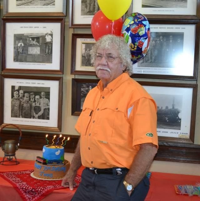 Jimmy French of Hollow Rock standing beside a birthday cake and balloons, remembered as one of the area’s most respected artifact collectors.