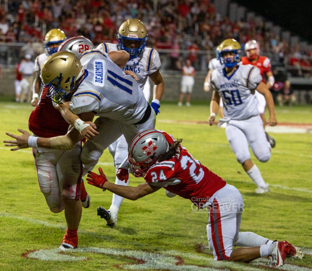 Huntingdon Mustangs quarterback Braylin Dearmon lunges forward for extra yards against the McKenzie Rebels in Carroll County, Tennessee. Dearmon rushed for 236 yards and two touchdowns in the 41-21 victory. Photo by Russell Bush/Huntingdon Sports Pics.