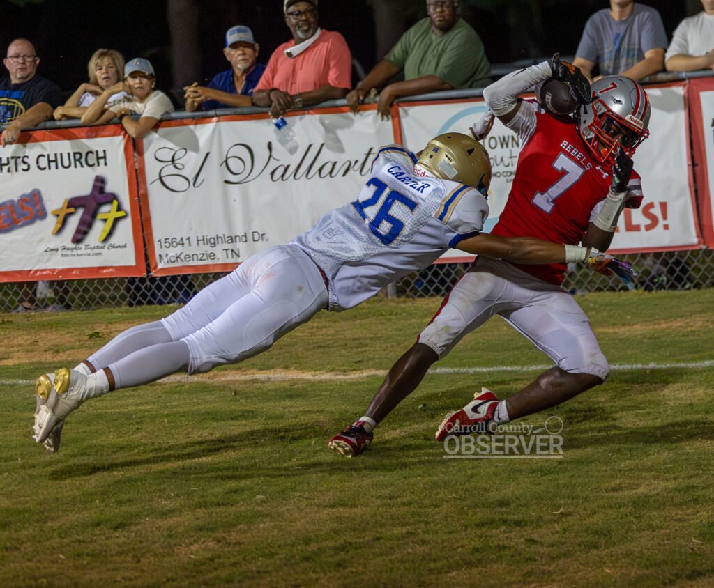 McKenzie Rebels receiver Jacobi Melton hauls in a touchdown catch off his helmet against the Huntingdon Mustangs in Carroll County, Tennessee. Melton’s score came in the Rebels’ 41-21 loss. Photo by Russell Bush/Huntingdon Sports Pics.