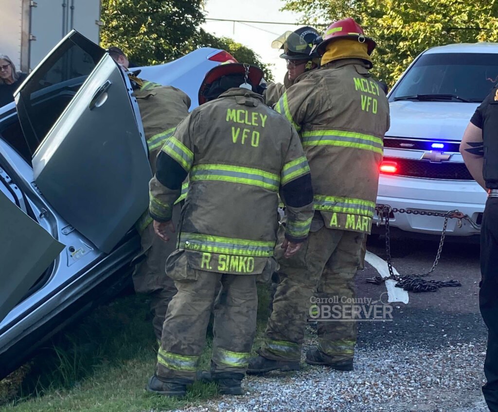 McLey Volunteer Fire Department firefighters work to stabilize a silver Buick that left the roadway and became stuck on the edge of a ditch on McLey Highway in Carroll County, Tennessee. Photo submitted to the Carroll County Observer.