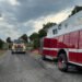 Fire trucks and emergency crews at Harris Road railroad crossing after fatal truck–train collision in Carroll County, Tennessee, on August 13, 2025.