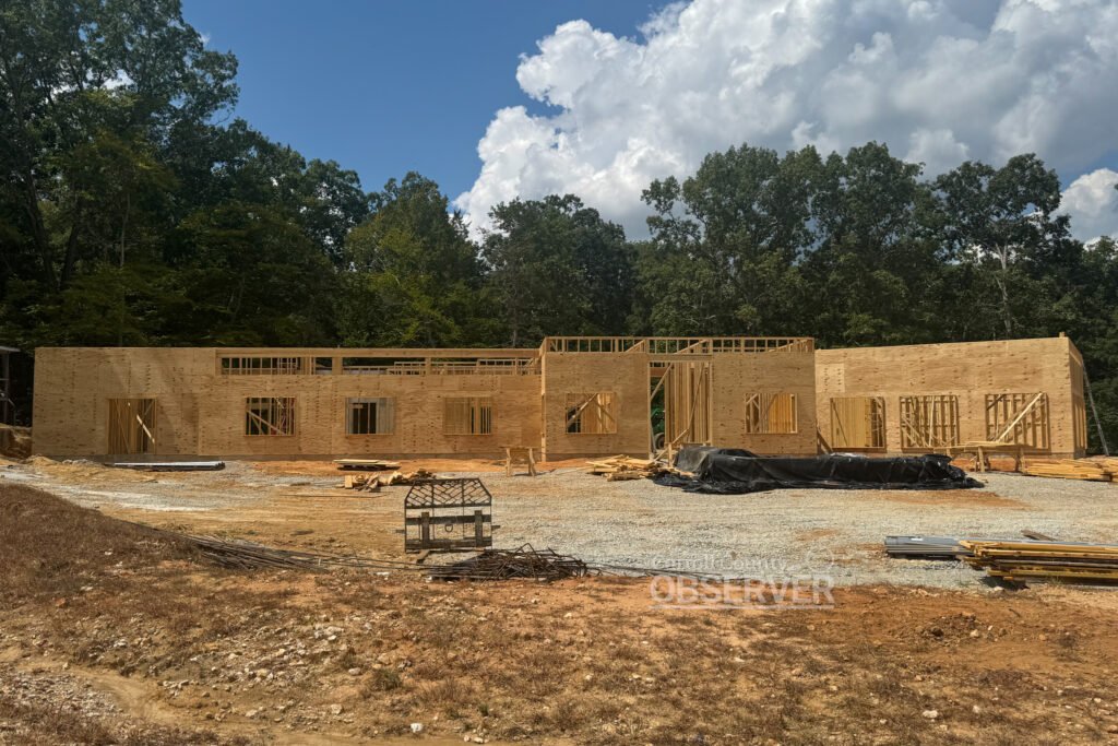 Framing and sheathing progress on the new Carroll County 911 office in Huntingdon, Tennessee, a facility designed for emergency services administration, training, and backup dispatch operations.
