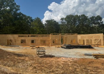 Framing and sheathing progress on the new Carroll County 911 office in Huntingdon, Tennessee, a facility designed for emergency services administration, training, and backup dispatch operations.
