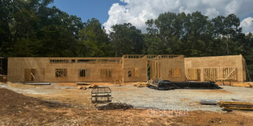 Framing and sheathing progress on the new Carroll County 911 office in Huntingdon, Tennessee, a facility designed for emergency services administration, training, and backup dispatch operations.
