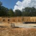 Framing and sheathing progress on the new Carroll County 911 office in Huntingdon, Tennessee, a facility designed for emergency services administration, training, and backup dispatch operations.