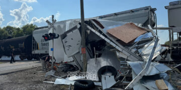 Race car hauler struck by CSX train at SR-105 crossing in Trezevant, Tennessee on August 15, 2025. Debris from the trailer scattered across the railroad crossing as crews worked overnight to clear the wreckage and repair damaged crossing gates. Photo by Jesse Joseph / Carroll County Observer
