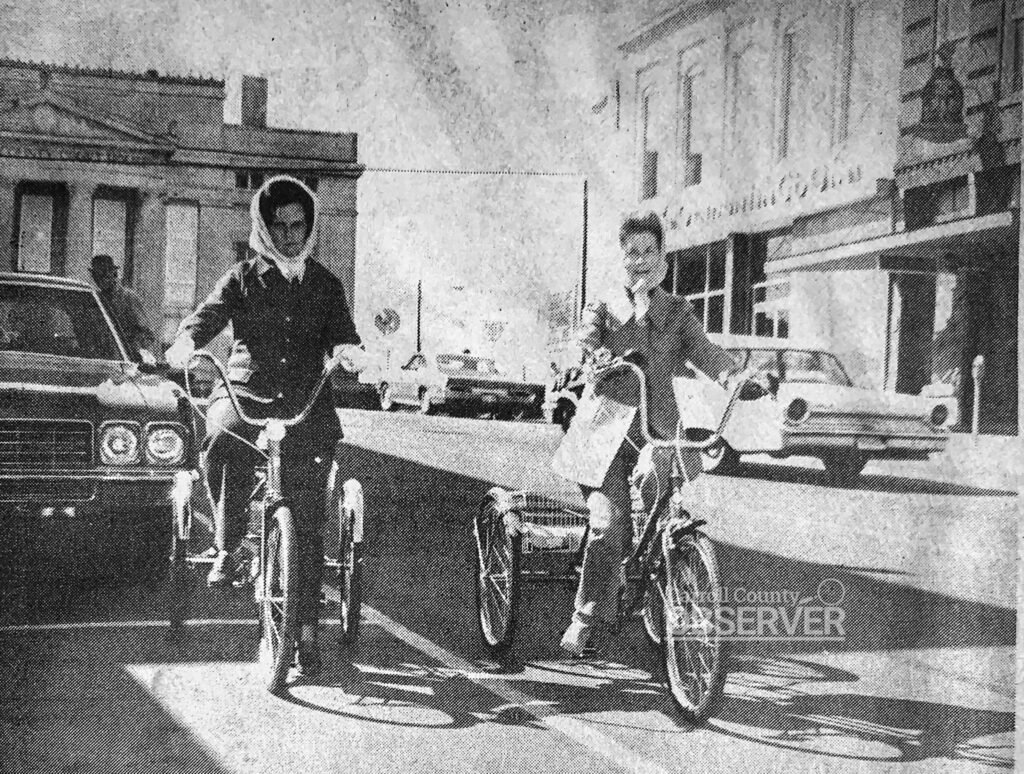 Historic photo from the late 1970s showing cyclists on Court Square in Huntingdon, Tennessee, with the Bank of Huntingdon building in the background before its 1982 remodel.
