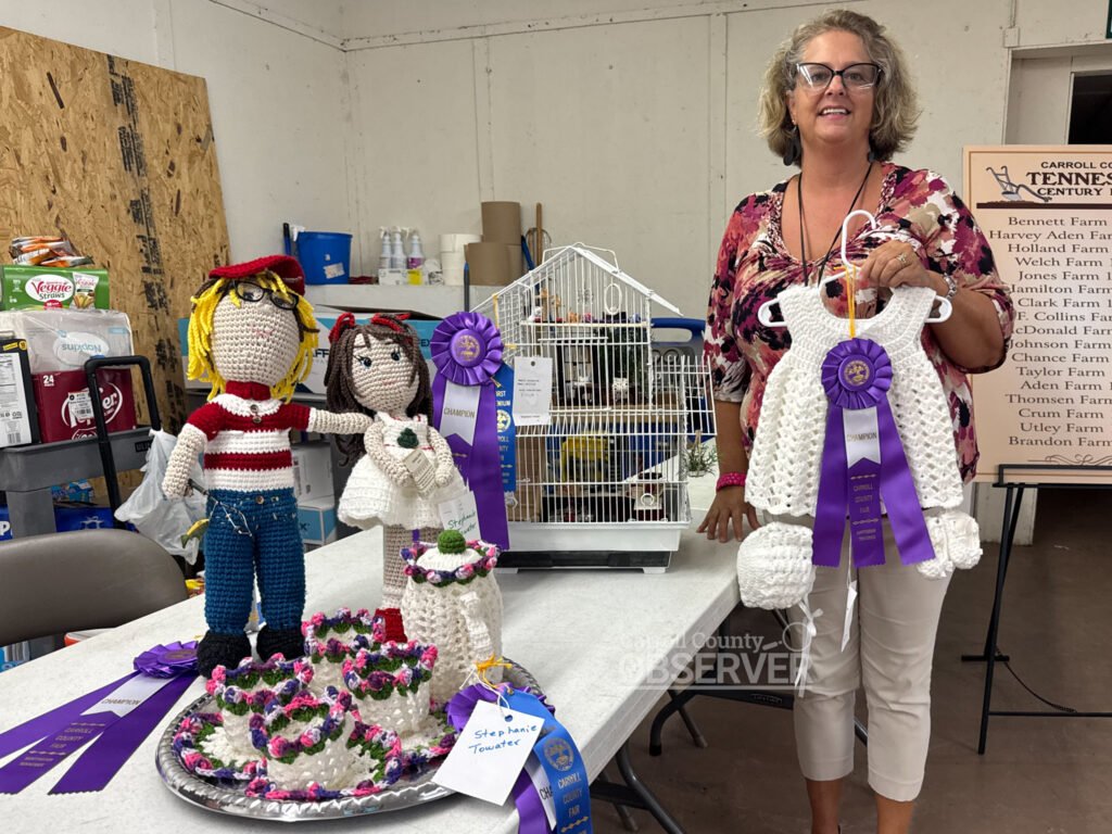 Stephanie Towater of Cedar Grove shows her purple ribbon-winning crocheted items and stuffed doll at the Carroll County Fair.