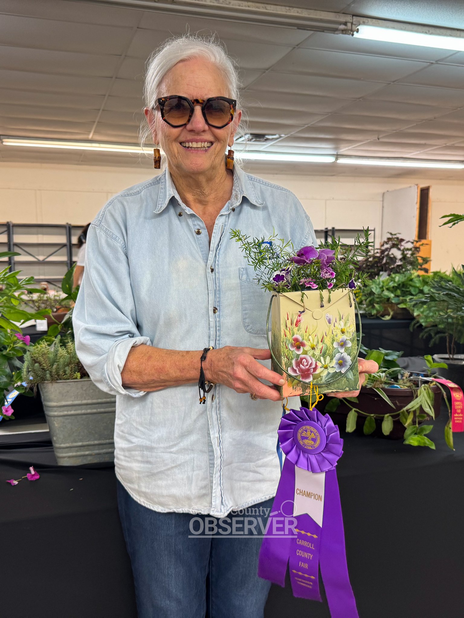 Paulette Crews of Huntingdon displays her purple ribbon-winning mixed cut flower arrangement at the Carroll County Fair.