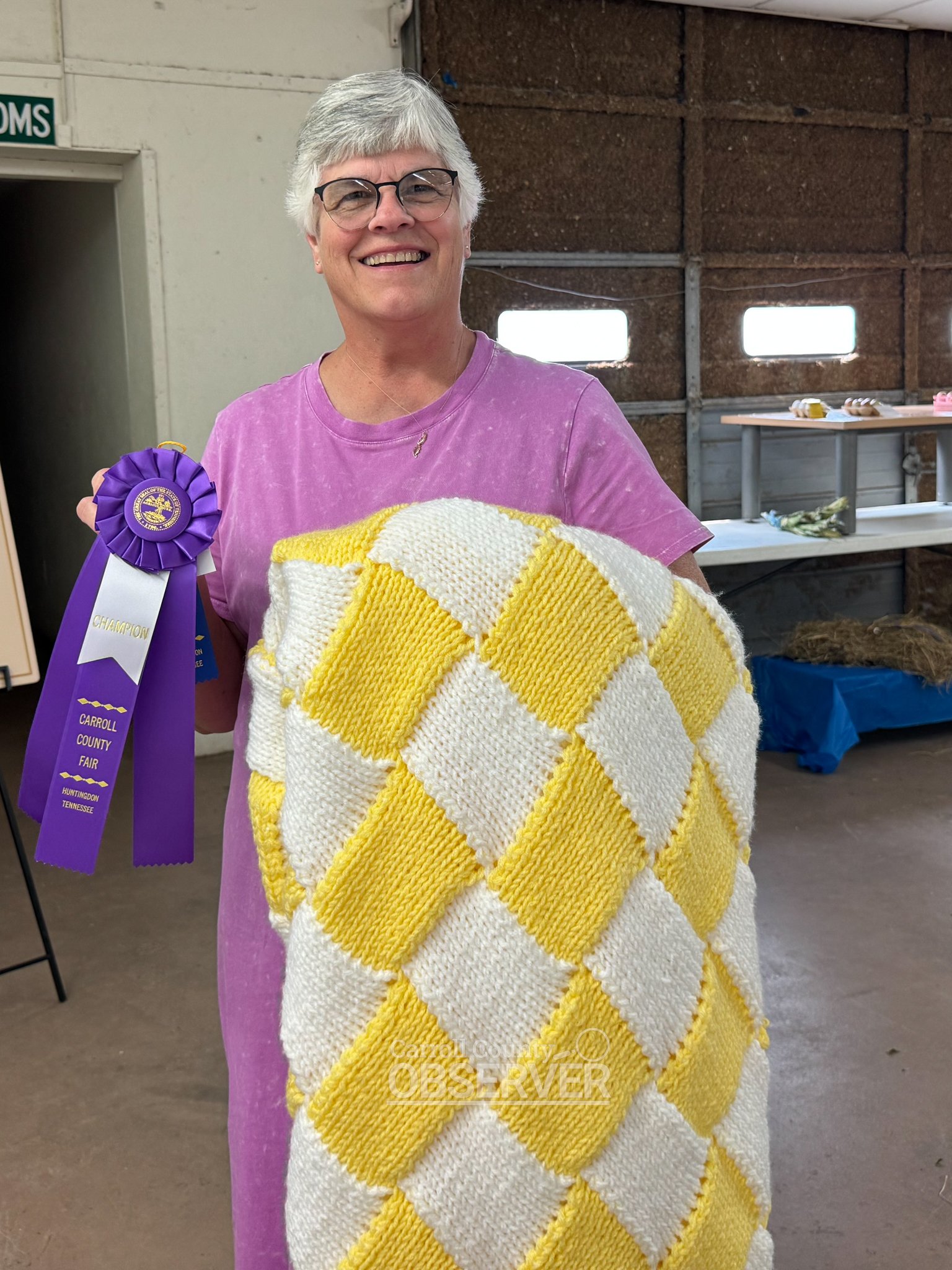 Gail Eubanks of Huntingdon with her knitted afghan, which earned a purple ribbon in the domestic arts category at the Carroll County Fair.