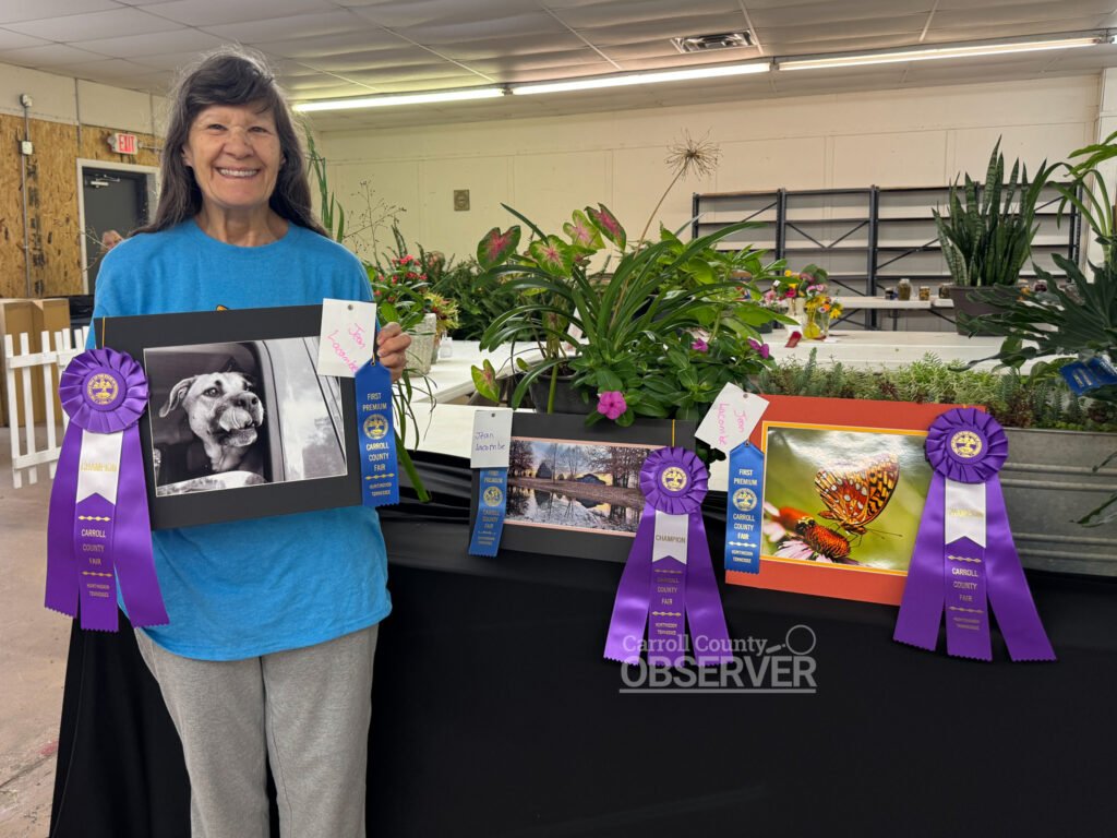 Alt text: Jean Lacombe of Huntingdon with her award-winning photographs in architecture, black and white, and flower categories at the Carroll County Fair.