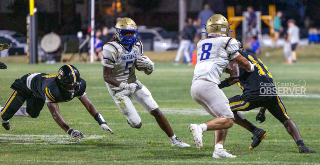 Mustang running back Tyreke Hutch makes a sharp cutback against the Halls defense, part of his 133-yard performance in the 49-6 victory.
