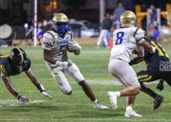 Mustang running back Tyreke Hutch makes a sharp cutback against the Halls defense, part of his 133-yard performance in the 49-6 victory.