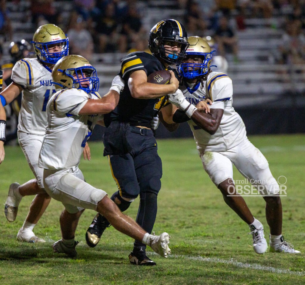 Two Huntingdon Mustang defenders team up to stop a Halls ball carrier during a dominant defensive effort in the 49-6 region victory.