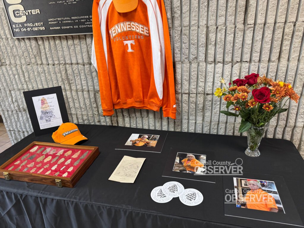 Tribute table for Jimmy French in the Civic Center foyer with photos, arrowheads, and memorabilia. Photo by Jesse Joseph/Carroll County Observer.