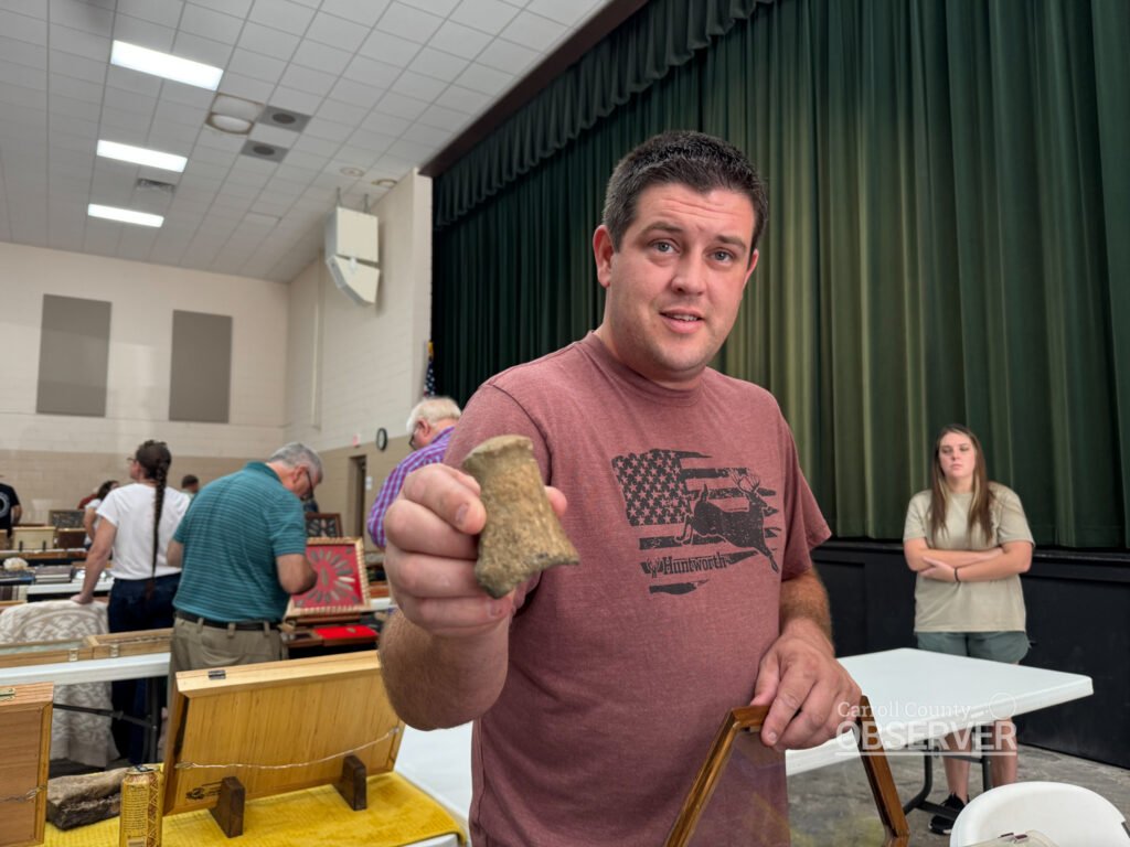 Jacob Tucker of Mississippi shows a fossilized dinosaur vertebrae at the Jimmy French Memorial Artifact Show. Photo by Jesse Joseph/Carroll County Observer.