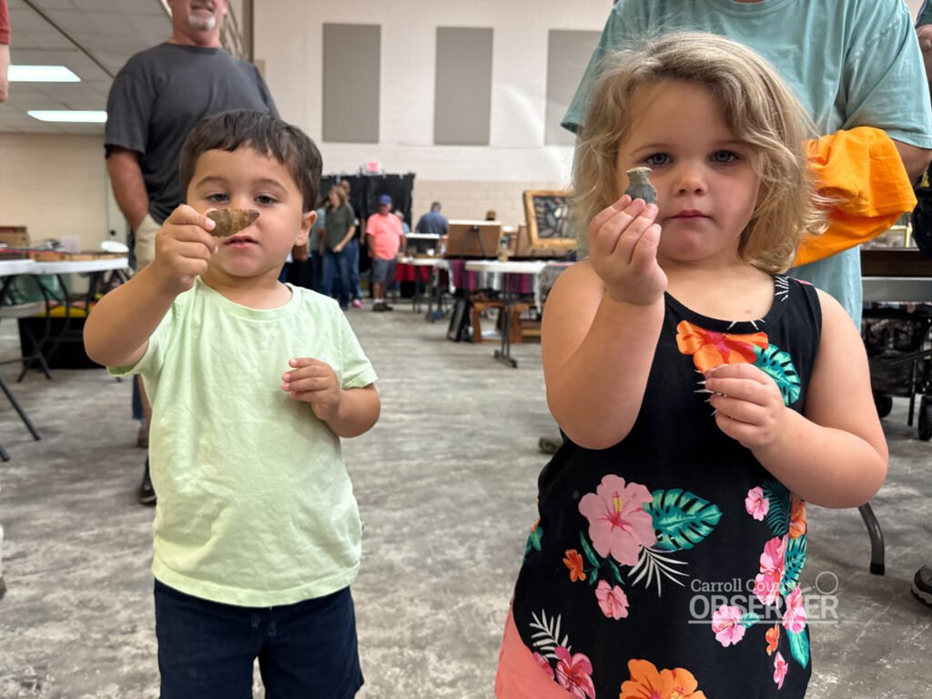 Children hold up arrowheads they received at the Jimmy French Memorial Artifact Show in Huntingdon. Photo by Jesse Joseph/Carroll County Observer.