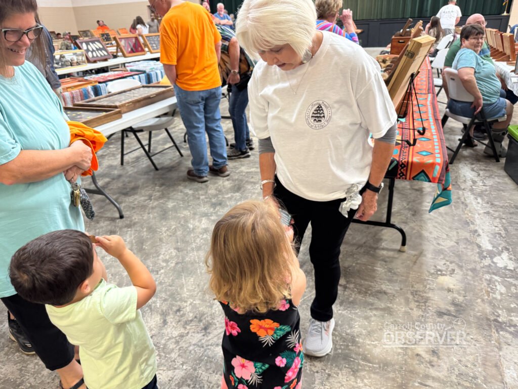 Carol Sue French greets children who received free arrowheads at the Jimmy French Memorial Artifact Show. Photo by Jesse Joseph/Carroll County Observer.