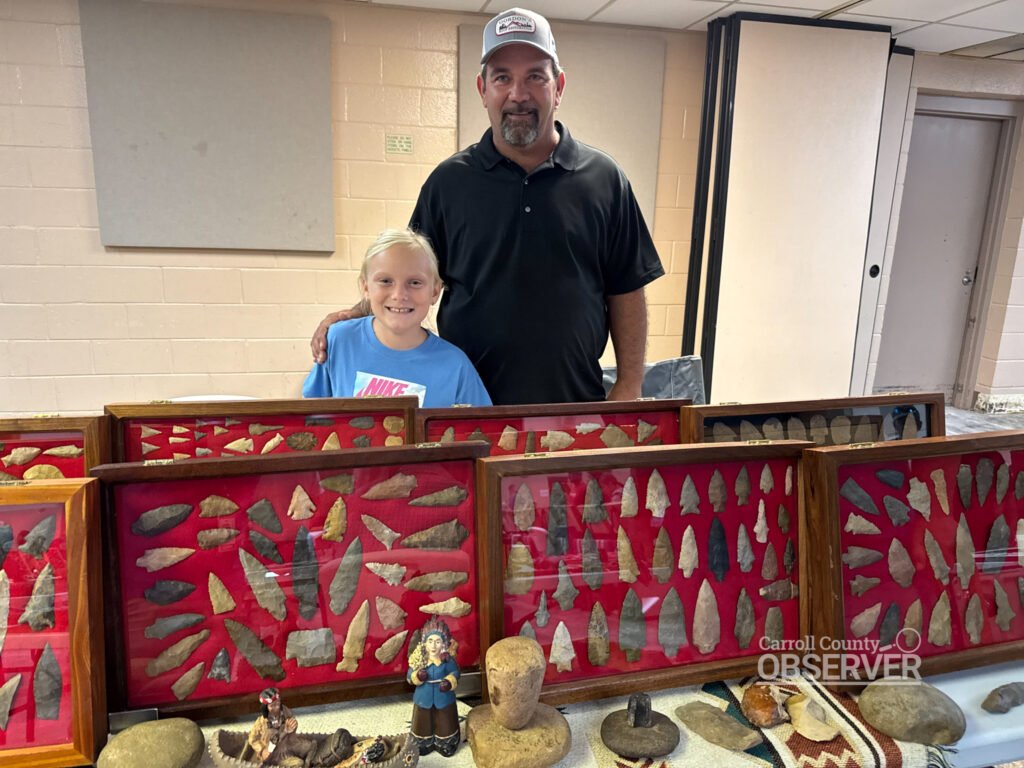 Jason Jeffries and daughter Lilly with their Carroll County artifact display at the Jimmy French Memorial Artifact Show. Photo by Jesse Joseph/Carroll County Observer.