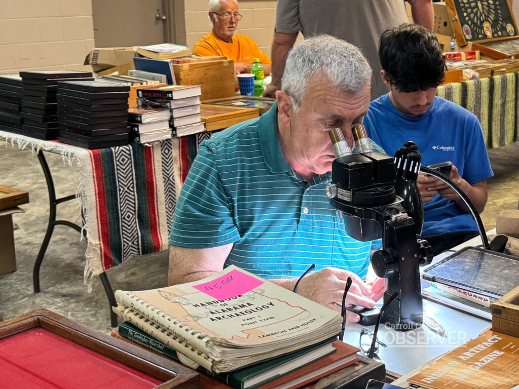 Jerry Dickey uses a microscope to authenticate an artifact at the Jimmy French Memorial Artifact Show. Photo by Jesse Joseph/Carroll County Observer.