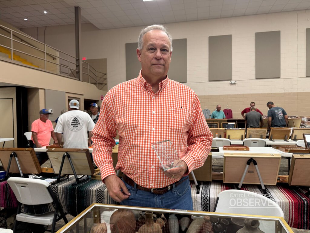 Collector Jeff Wilkes holds his Best Display plaque at the Jimmy French Memorial Artifact Show in Carroll County. Photo by Jesse Joseph/Carroll County Observer.