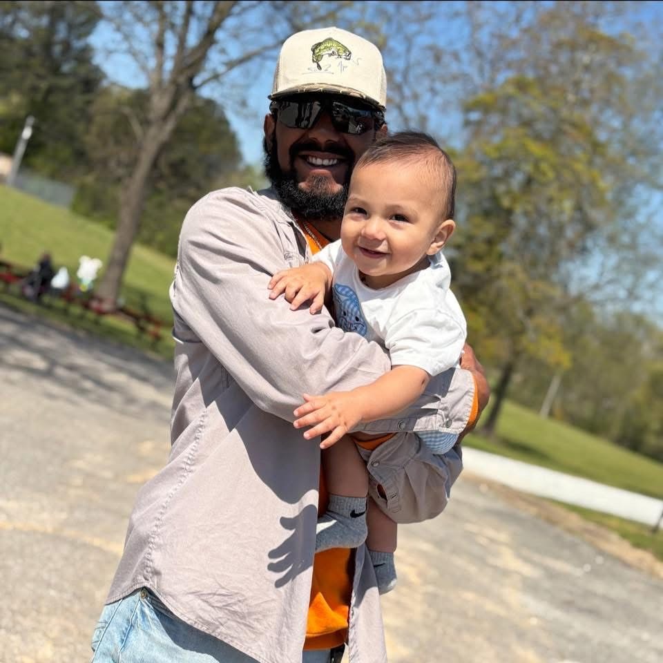 Martin Perez, a 2018 McKenzie High School graduate and lineman for Drewry Communications, was killed in a train collision in McKenzie, Tennessee. He is pictured holding his young child.