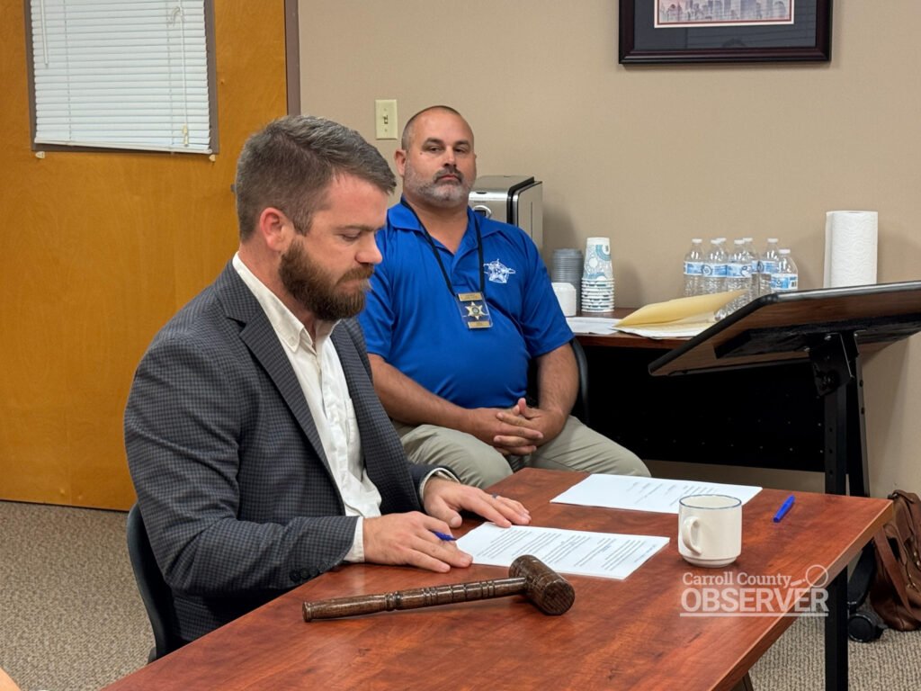 Carroll County Mayor Joseph Butler addresses commissioners about the Harris Road train collision while Chief Deputy Joel Pate sits nearby. Butler pledged that the county will pursue real, achievable safety solutions. Photo by Jesse Joseph/Carroll County Observer.