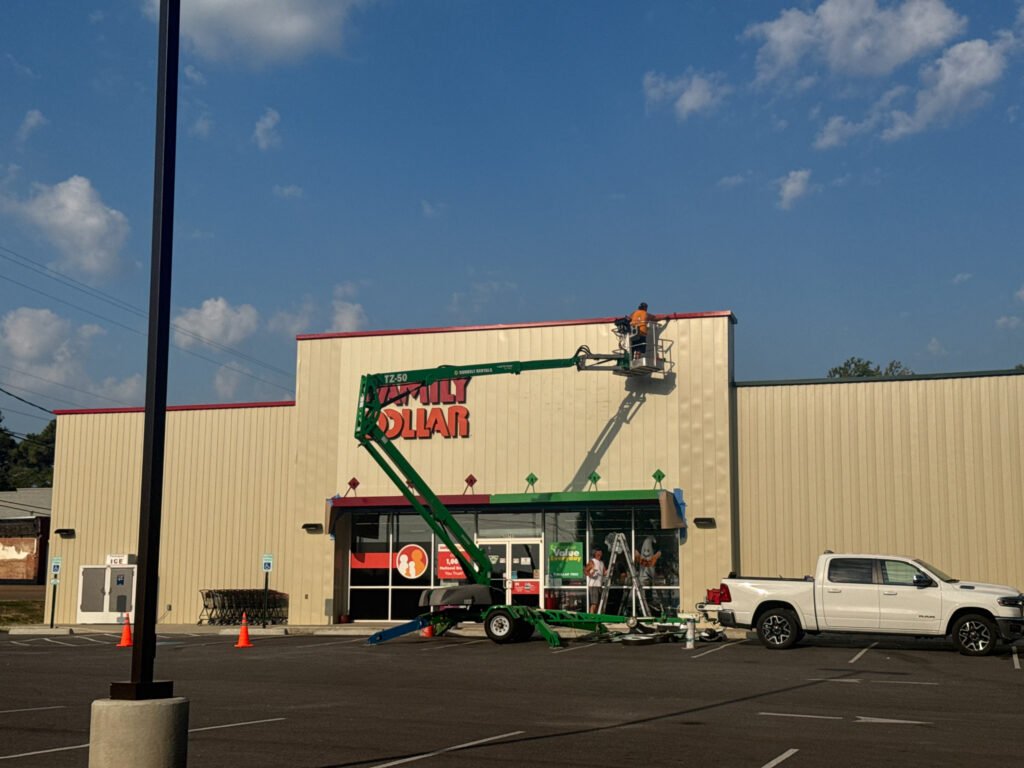 Workers remove Dollar Tree signs from the Family Dollar combo store in Bruceton, Carroll County, Tennessee, on September 17, 2025, after the national retailer’s $1 billion Family Dollar sale and widespread store closures.