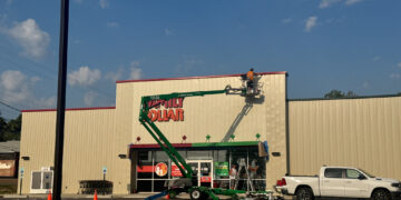 Workers remove Dollar Tree signs from the Family Dollar combo store in Bruceton, Carroll County, Tennessee, on September 17, 2025, after the national retailer’s $1 billion Family Dollar sale and widespread store closures.