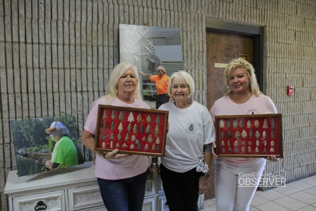 Elizabeth Reeves, Carol Sue French, and Angie Vaughan with arrowhead cases created by Jimmy French at the artifact show. Photo by Jesse Joseph/Carroll County Observer.