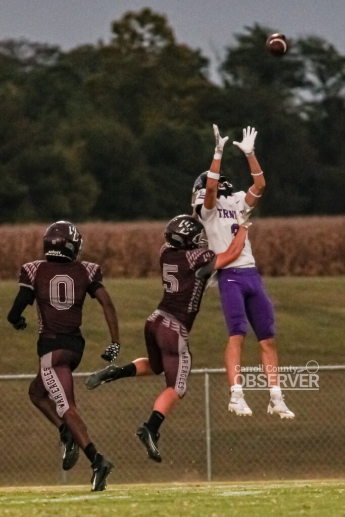 Trinity Christian Academy receiver makes a leaping catch over West Carroll War Eagles defenders during a high school football game in Atwood, TN, September 12, 2025.
