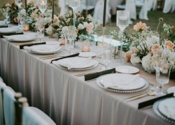 Beautifully decorated wedding reception table with floral arrangements and elegant tableware.