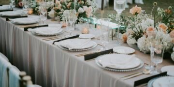 Beautifully decorated wedding reception table with floral arrangements and elegant tableware.