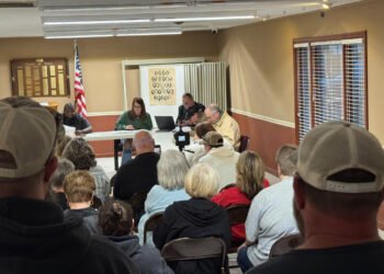 Crowd of residents seated at Atwood Town Hall facing the board table during the March 12 meeting.