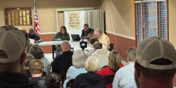 Crowd of residents seated at Atwood Town Hall facing the board table during the March 12 meeting.