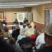 Crowd of residents seated at Atwood Town Hall facing the board table during the March 12 meeting.