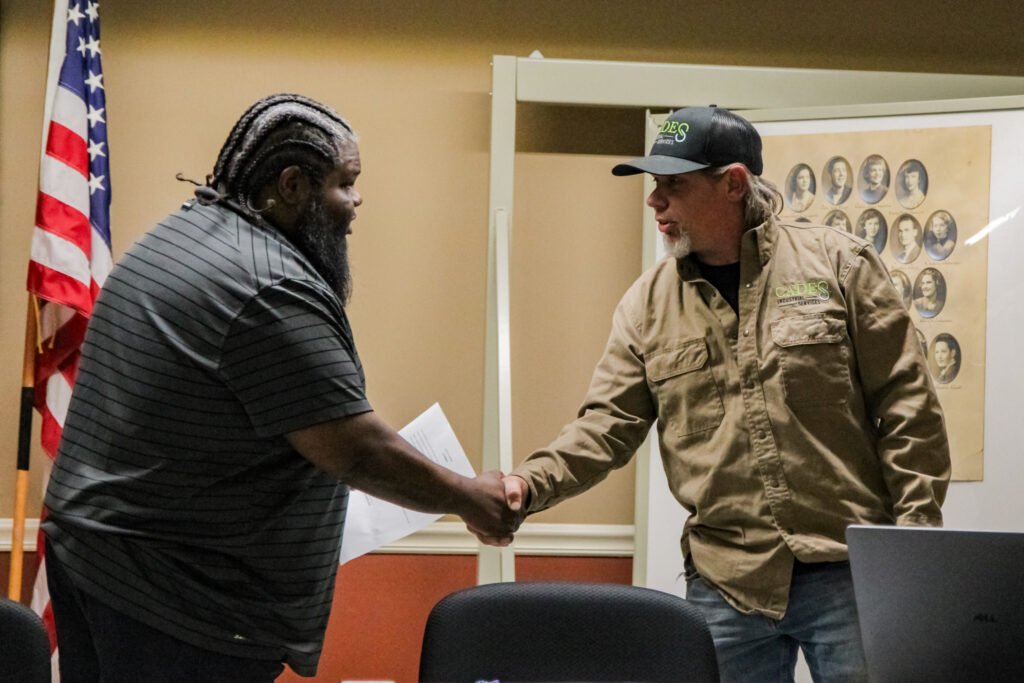 Mayor Fridie Agee and Alderman Tommy Polinski shake hands after the swearing-in ceremony at Atwood Town Hall.