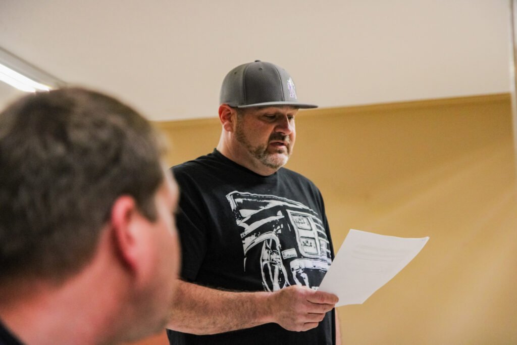 TJ Herndon stands reading from a document during public comment at the Atwood town meeting.