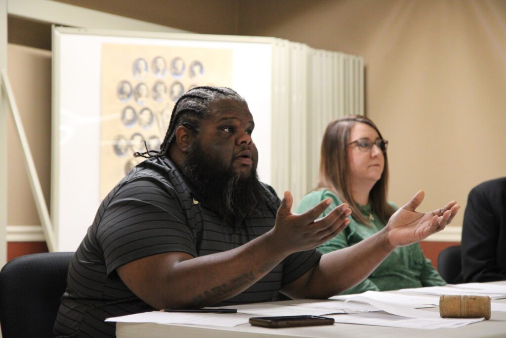 Mayor Fridie Agee gestures with both hands while speaking at the board table, with City Recorder Amanda Browning seated beside him.