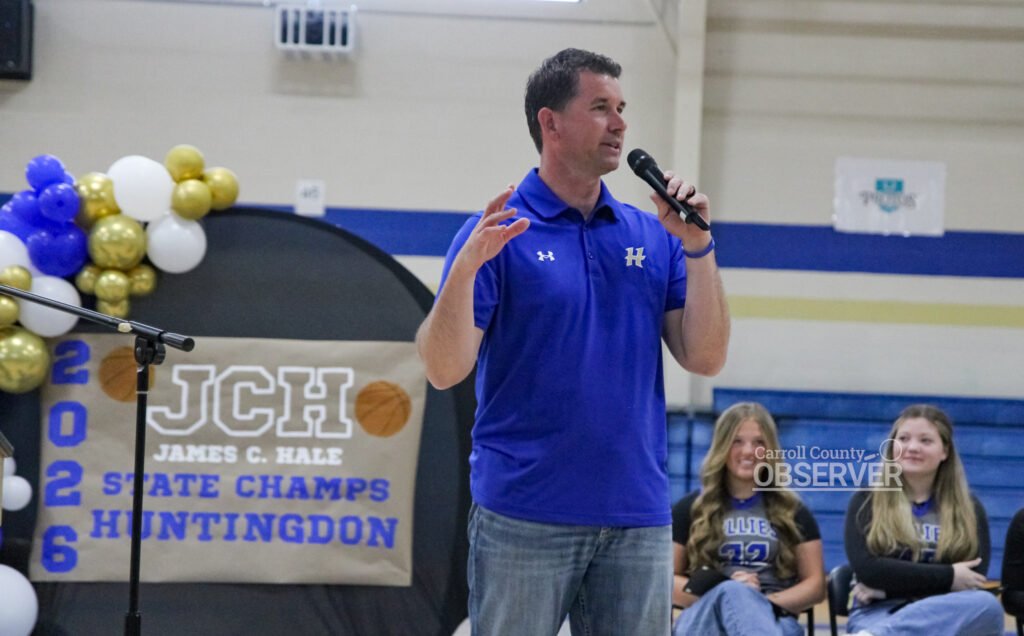 Dr. Jonathan Kee speaking with microphone at HMS Fillies state championship celebration.