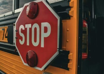 Detailed image of a 'STOP' sign on a school bus, emphasizing safety and transport.