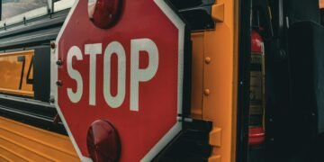 Detailed image of a 'STOP' sign on a school bus, emphasizing safety and transport.