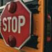 Detailed image of a 'STOP' sign on a school bus, emphasizing safety and transport.