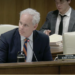 Sen. John Stevens sits at a committee table with his nameplate visible.