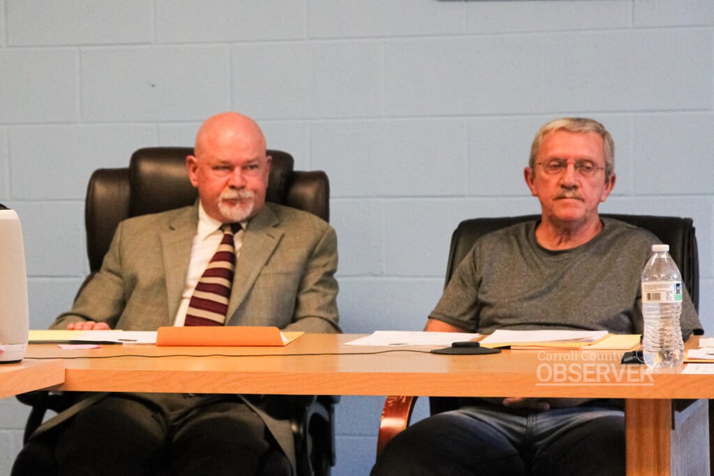 Bruceton Mayor Robert T. Keeton, III and alderman seated at meeting table
