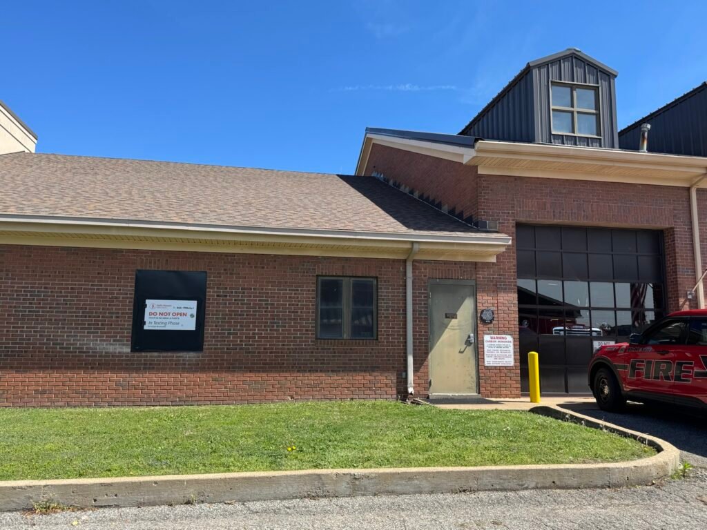 Exterior of McKenzie Fire Department with a Safe Haven Baby Box mounted on the brick wall.