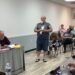 Trezevant resident John Quinn standing and addressing the board at April 2026 meeting with Alderman Mark Argo seated at table.