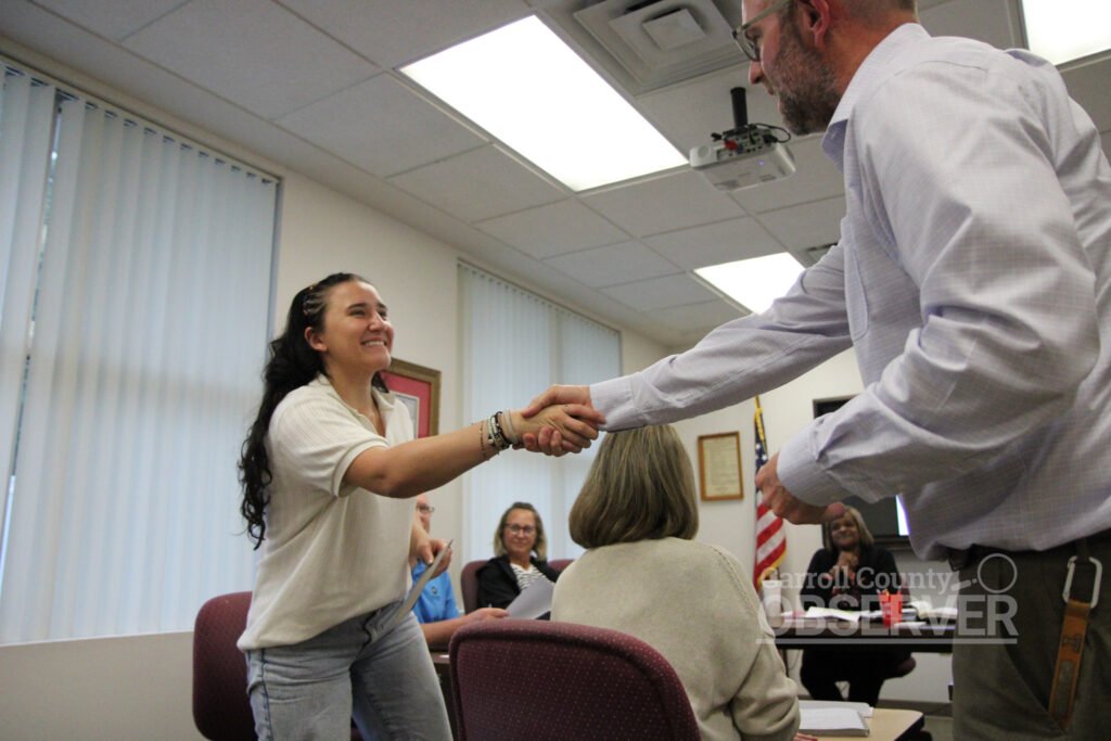 Gracie Aird shakes hands with Dr Justin Barden at McKenzie school board meeting May 5 2026
