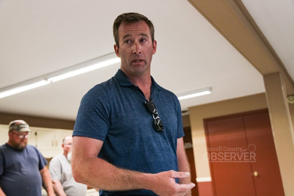 Andrew Davis stands and speaks to the Atwood board during a town meeting at Atwood City Hall.